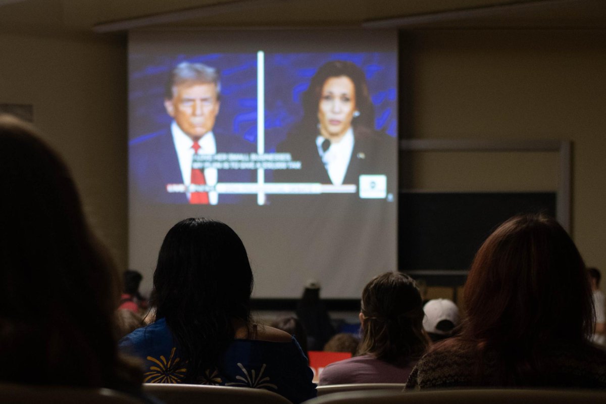 Students watch the debate between Vice President Kamala Harris and former President Donald Trump during the College Democrats debate watch party on Tuesday.
