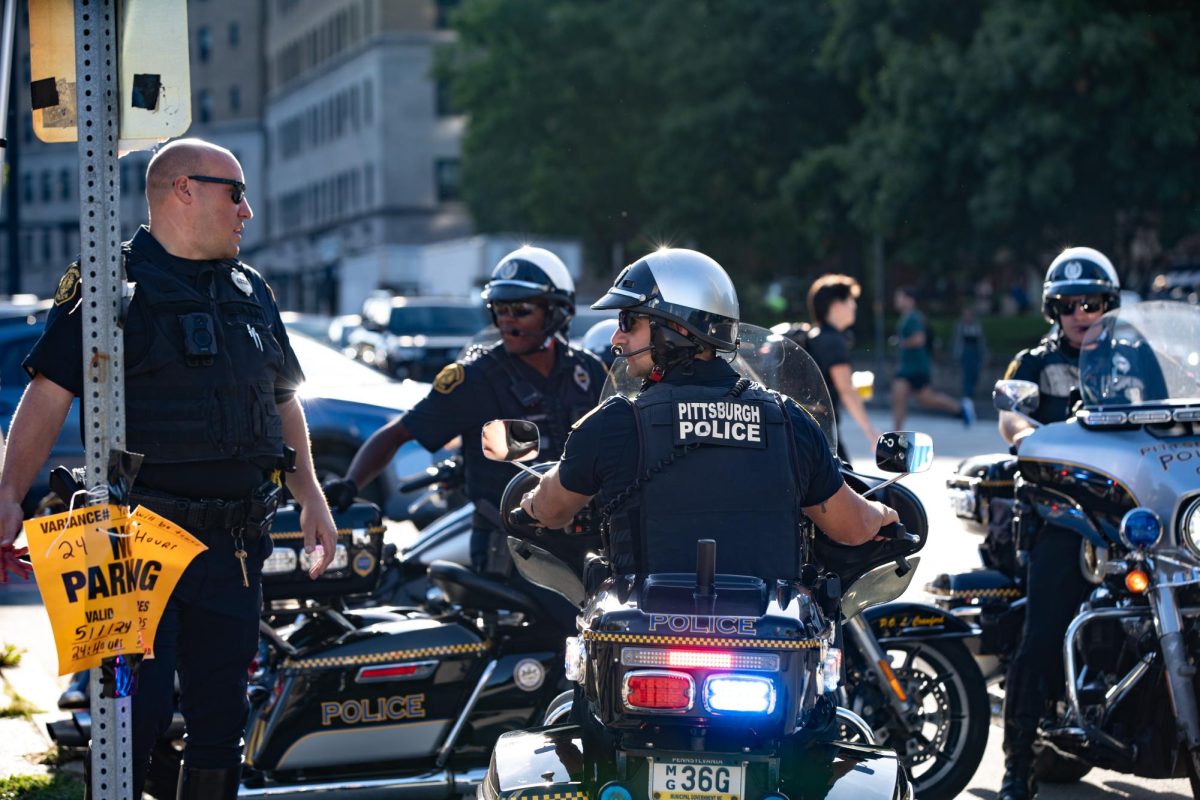 Police watch protesters during the event at Schenley Plaza on Tuesday.
