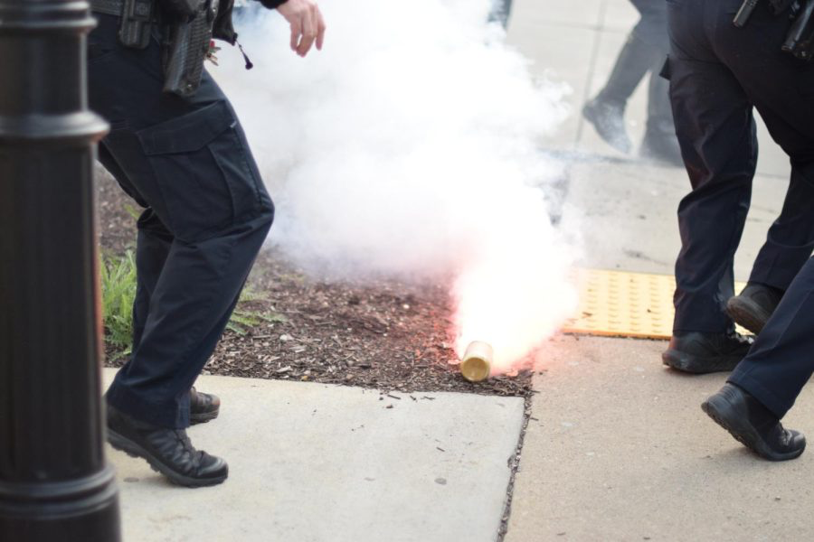 A smoke bomb lands on the ground after a series of two protests against of debate featuring Michael Knowles in April 2023.
