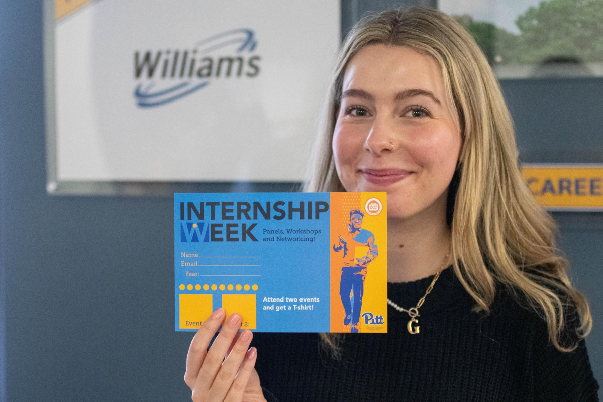 An Internship Week representative holds an Internship Week flyer.