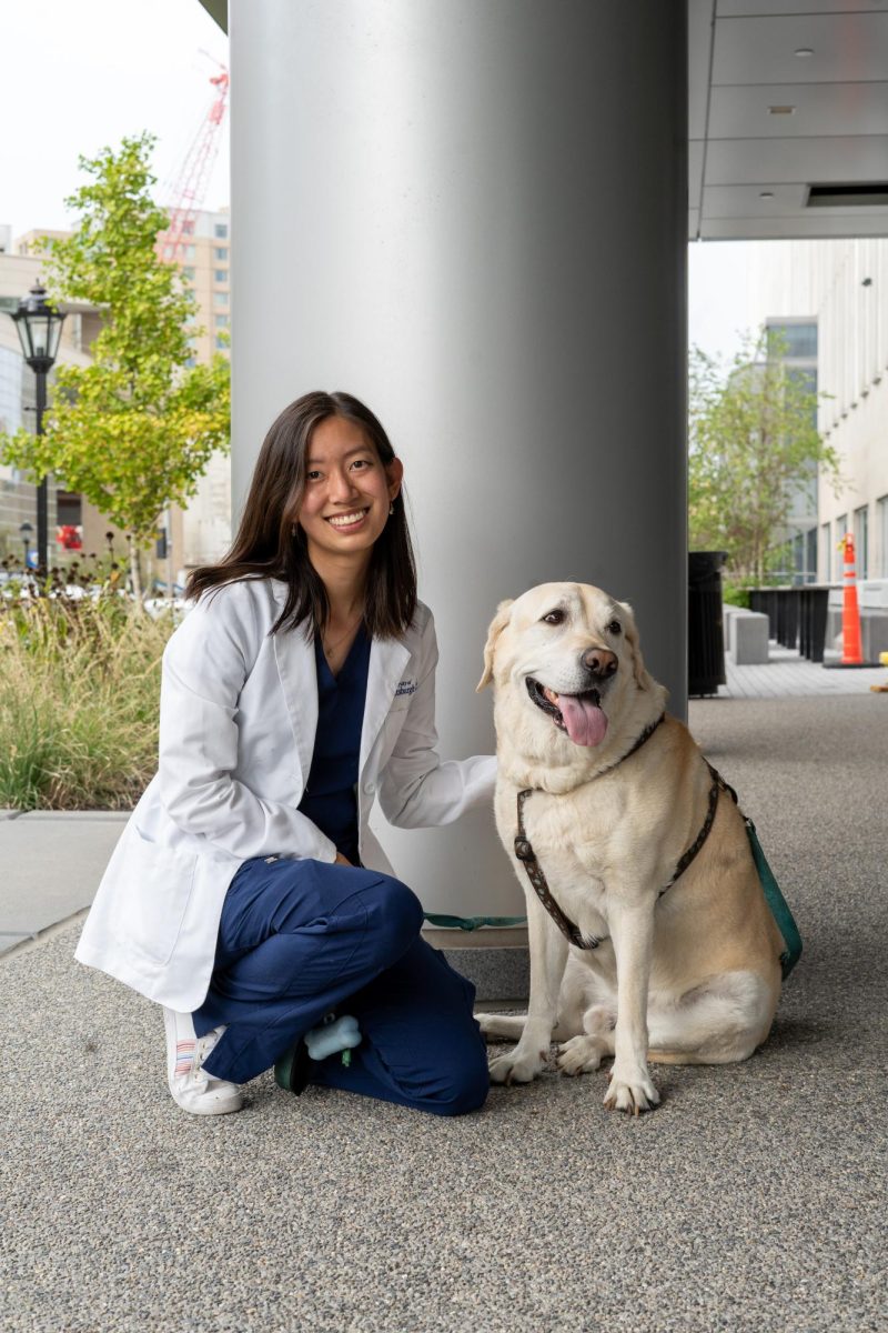 Anna Li, winner of the Hult Prize, poses with a dog.
