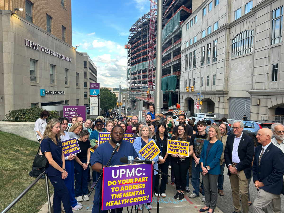 Mental health advocates stand outside UPMC Western Psychiatric Hospital.
