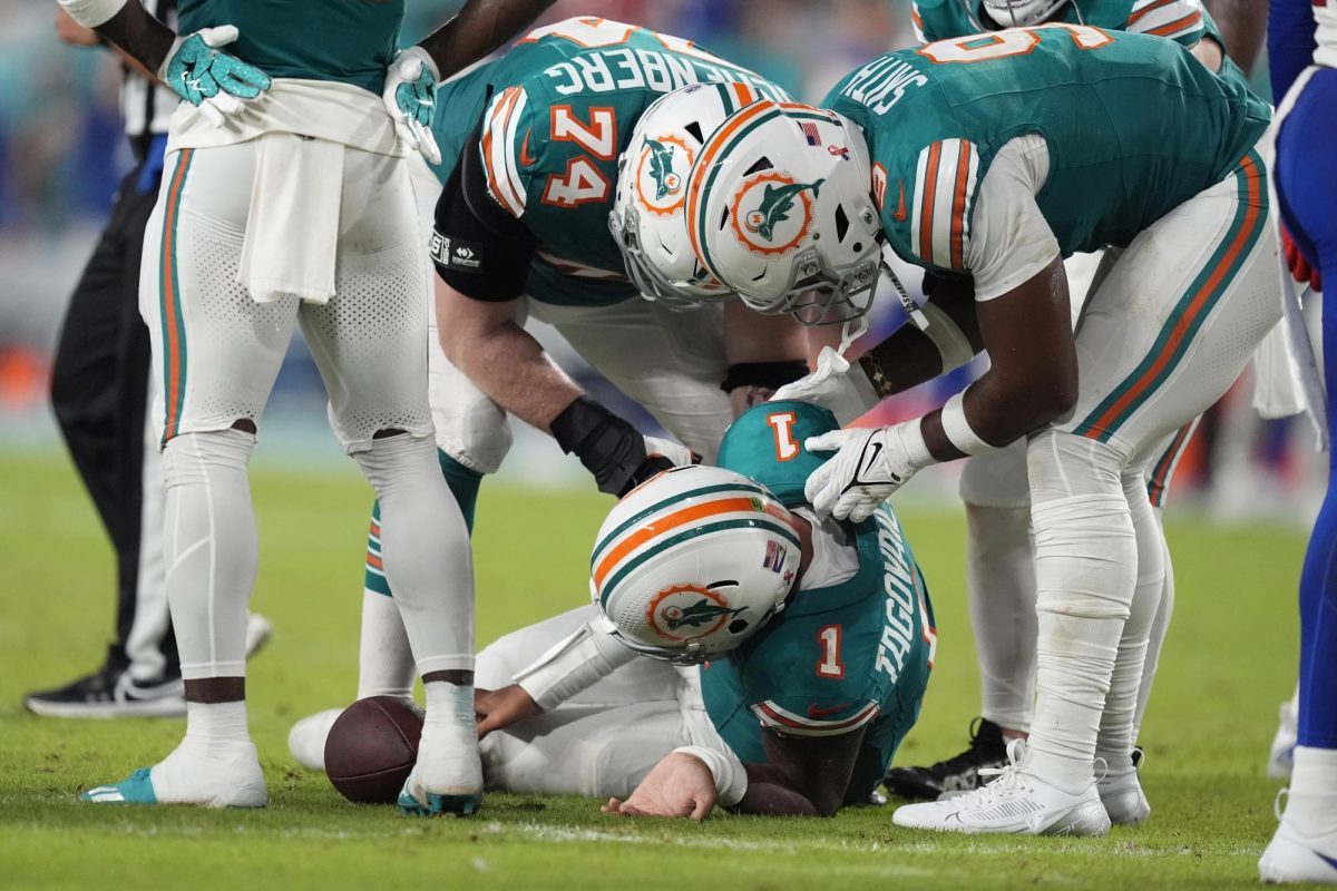 Miami Dolphins quarterback Tua Tagovailoa (1) lies on the field after suffering a concussion during the second half of an NFL football game against the Buffalo Bills, Thursday, Sept. 12, in Miami Gardens, Fla.
