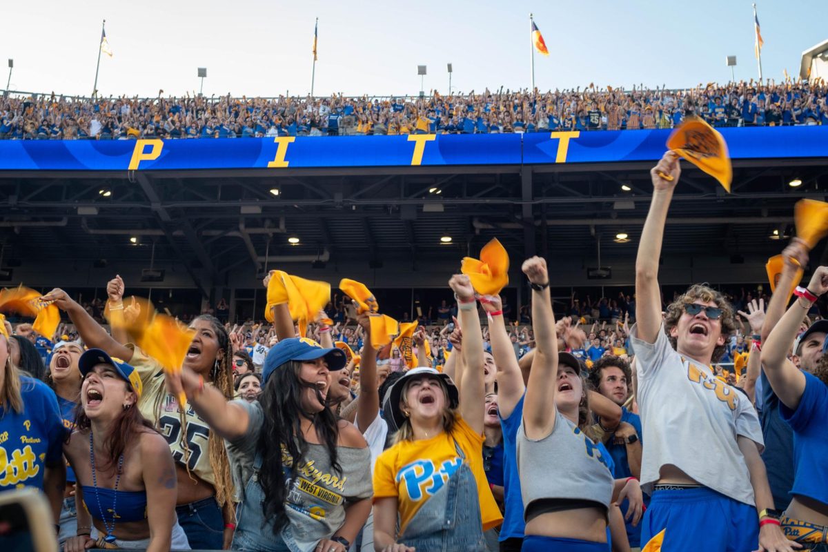 Pitt students excitedly wave their rally towels at the Backyard Brawl against West Virginia on Saturday.
