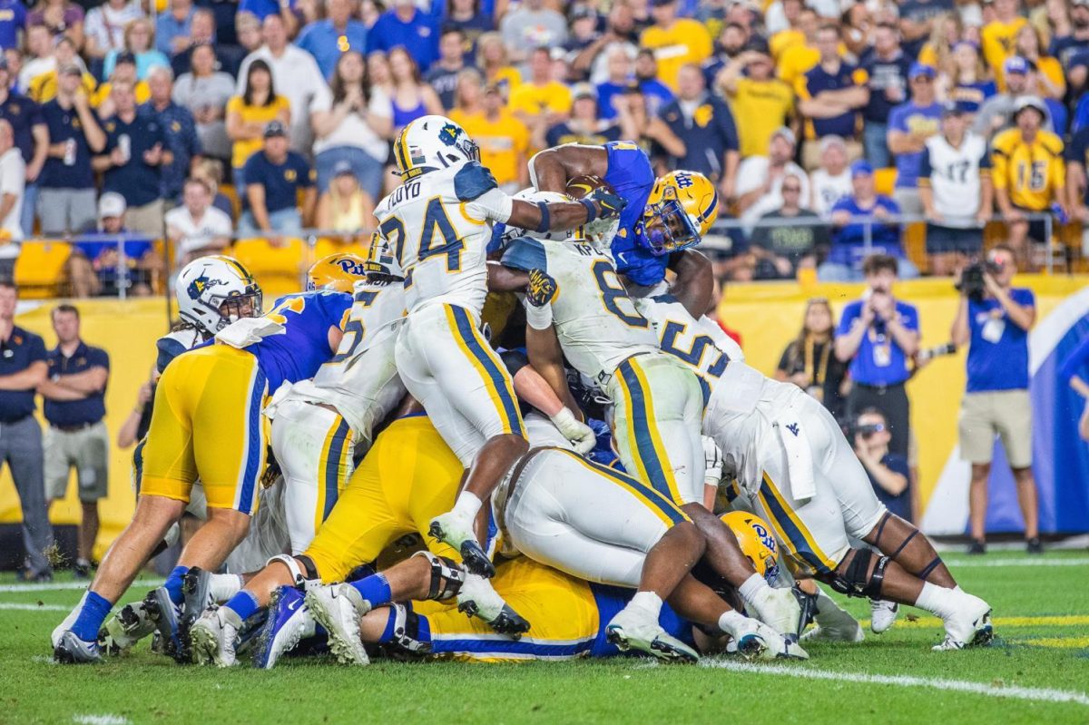 Players pile on each other during the Backyard Brawl on Thursday, Sept. 1, 2022.