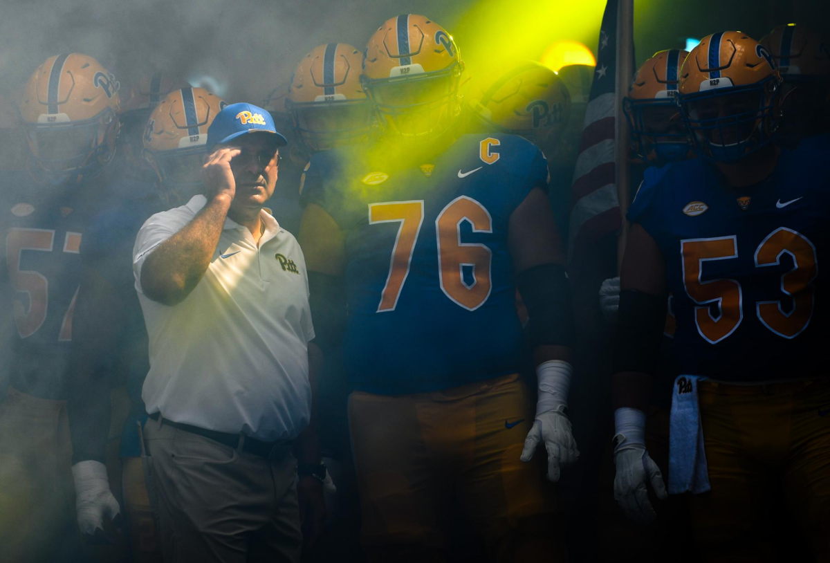 Pitt football prepares to enter the field with head coach Pat Narduzzi.
