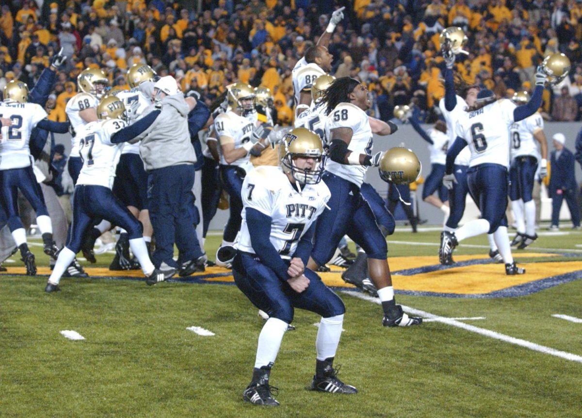 Pittsburgh's Steve Malinchak (7) and teammates celebrate their 13-9 upset win over No. 2 West Virginia Dec. 1, 2007, in Morgantown, W.Va.