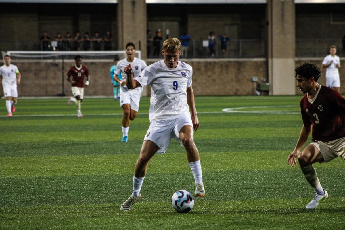 Sophomore forward Albert Thorsen (9) guides the ball down the field at Friday’s soccer game against Boston College at Ambrose Urbanic Field.
