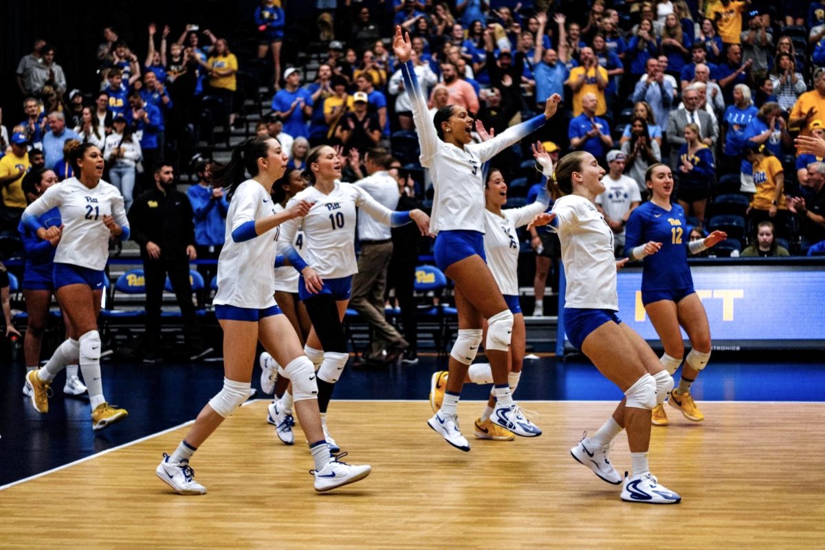 Pitt volleyball celebrates a win in the Fitzgerald Field House.