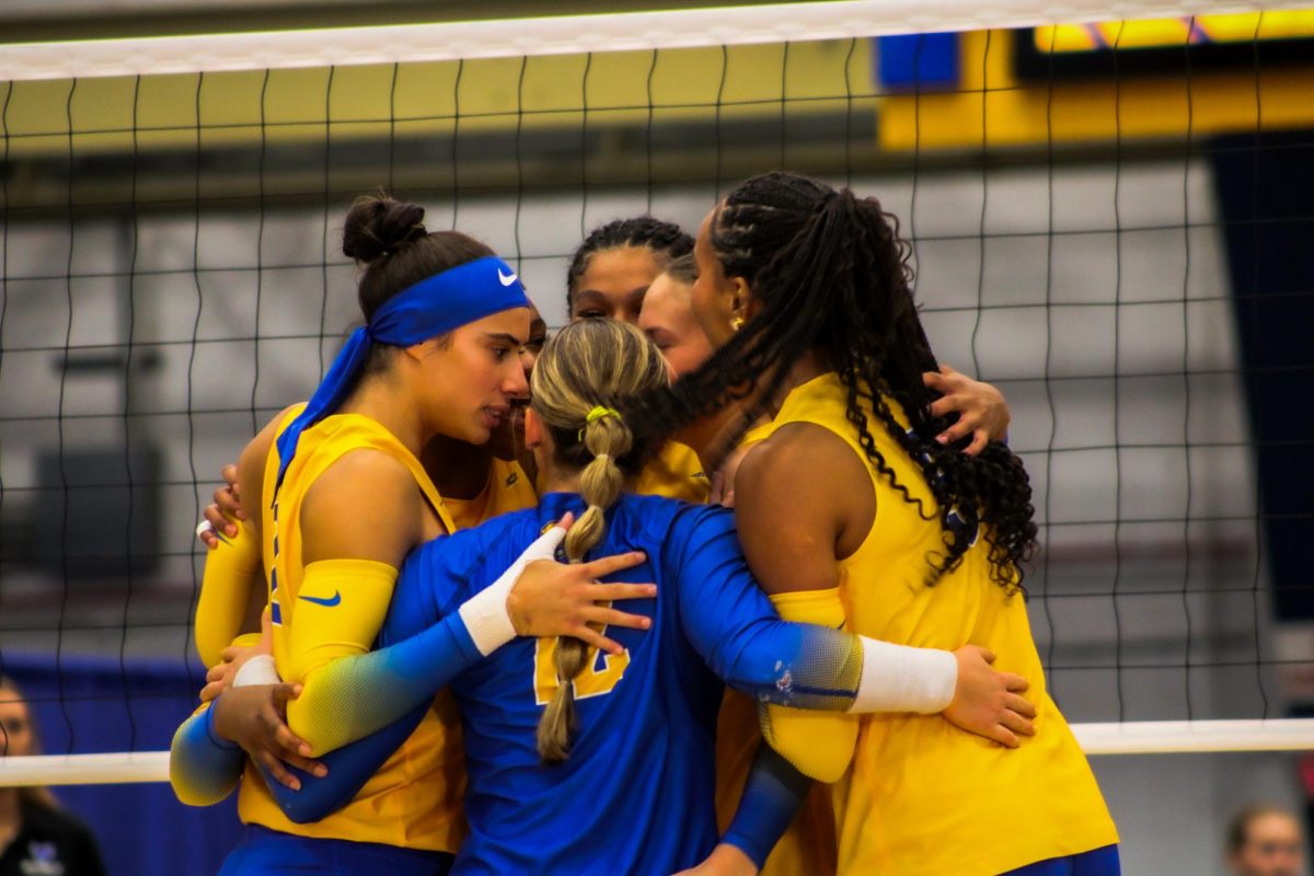 Pitt volleyball players huddle after a point during their game against Buffalo on Tuesday at Fitzgerald Field House.