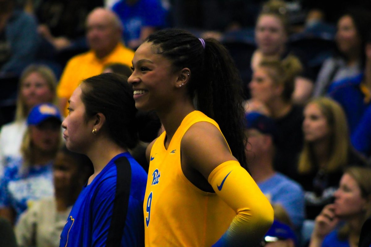 First-year middle blocker Ryla Jones (9) smiles during Pitt volleyball’s game against Buffalo on Tuesday at Fitzgerald Field House.