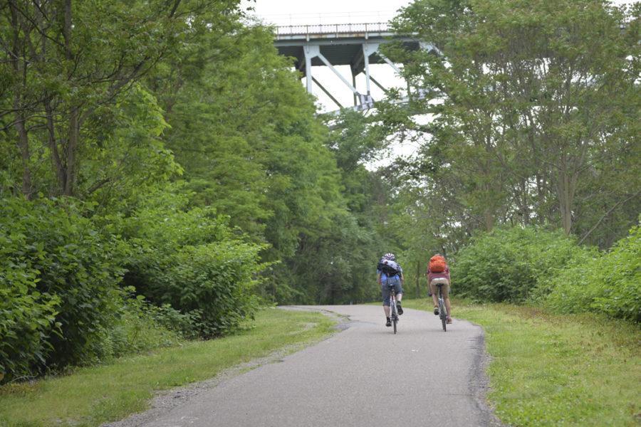 Bikers ride along a path in Schenley Park.