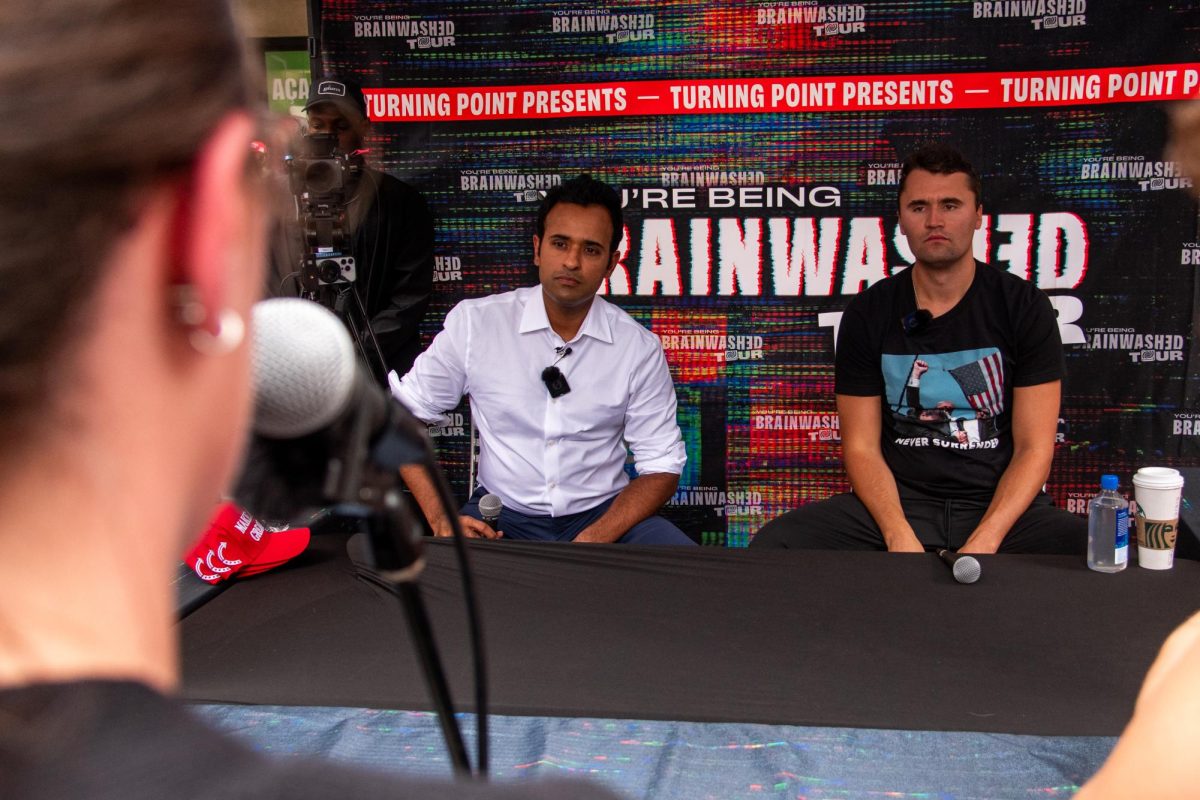 Charlie Kirk and Vivek Ramaswamy listen to a student ask a question during TPUSA’s “You’re Being Brainwashed” tour event in the Schenley Quadrangle on Wednesday.