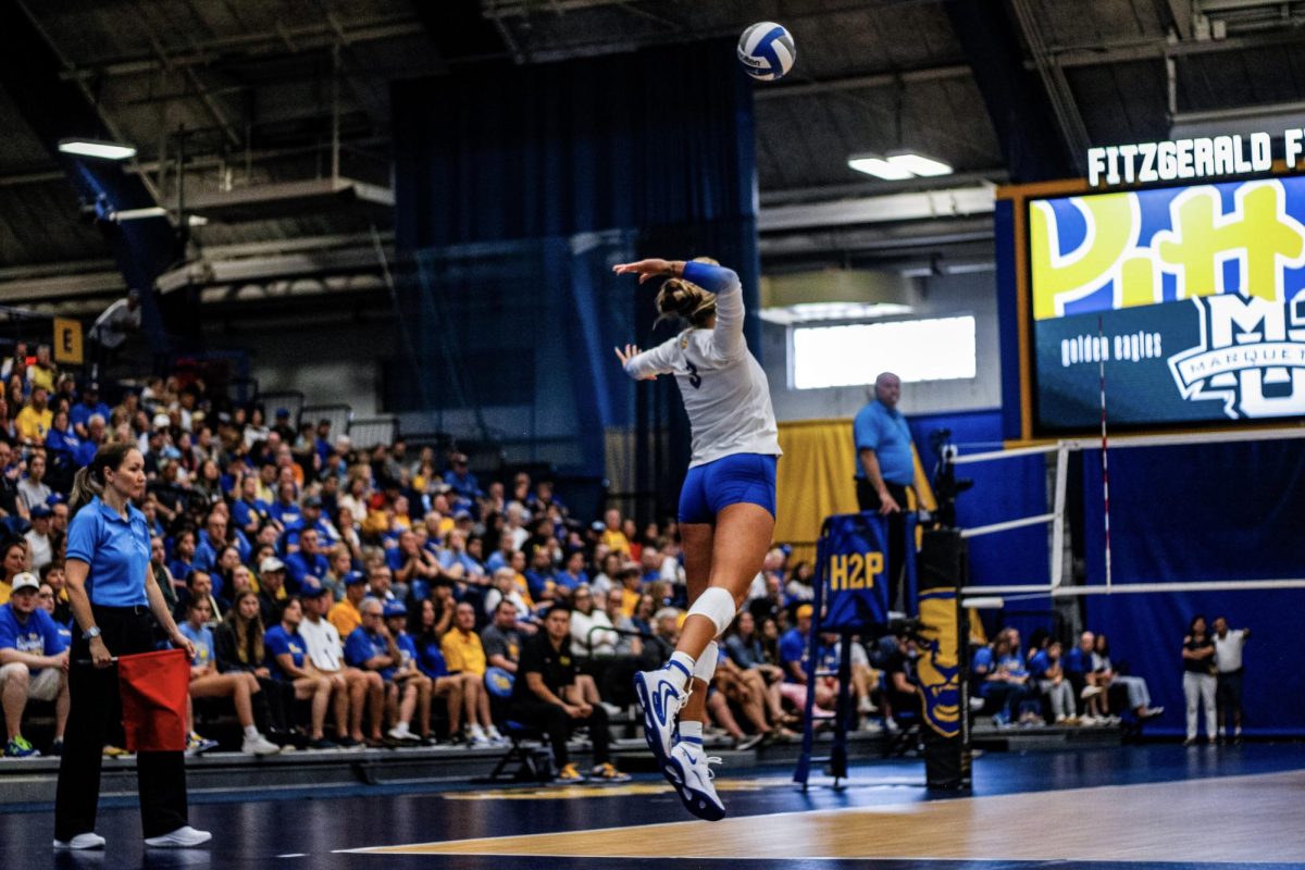 Graduate student outside hitter Cat Flood (3) prepares to strike the ball at the volleyball match against Marquette at the Fitzgerald Field House on Sunday.