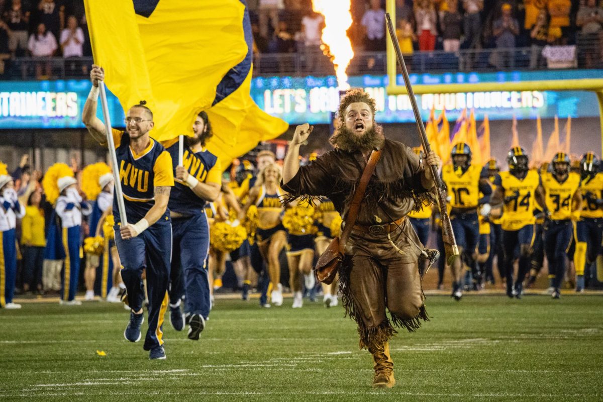 The West Virginia Mountaineer mascot charges onto the field ahead of the players before the Backyard Brawl in Morgantown, West Virginia, on Saturday, Sept. 16, 2023