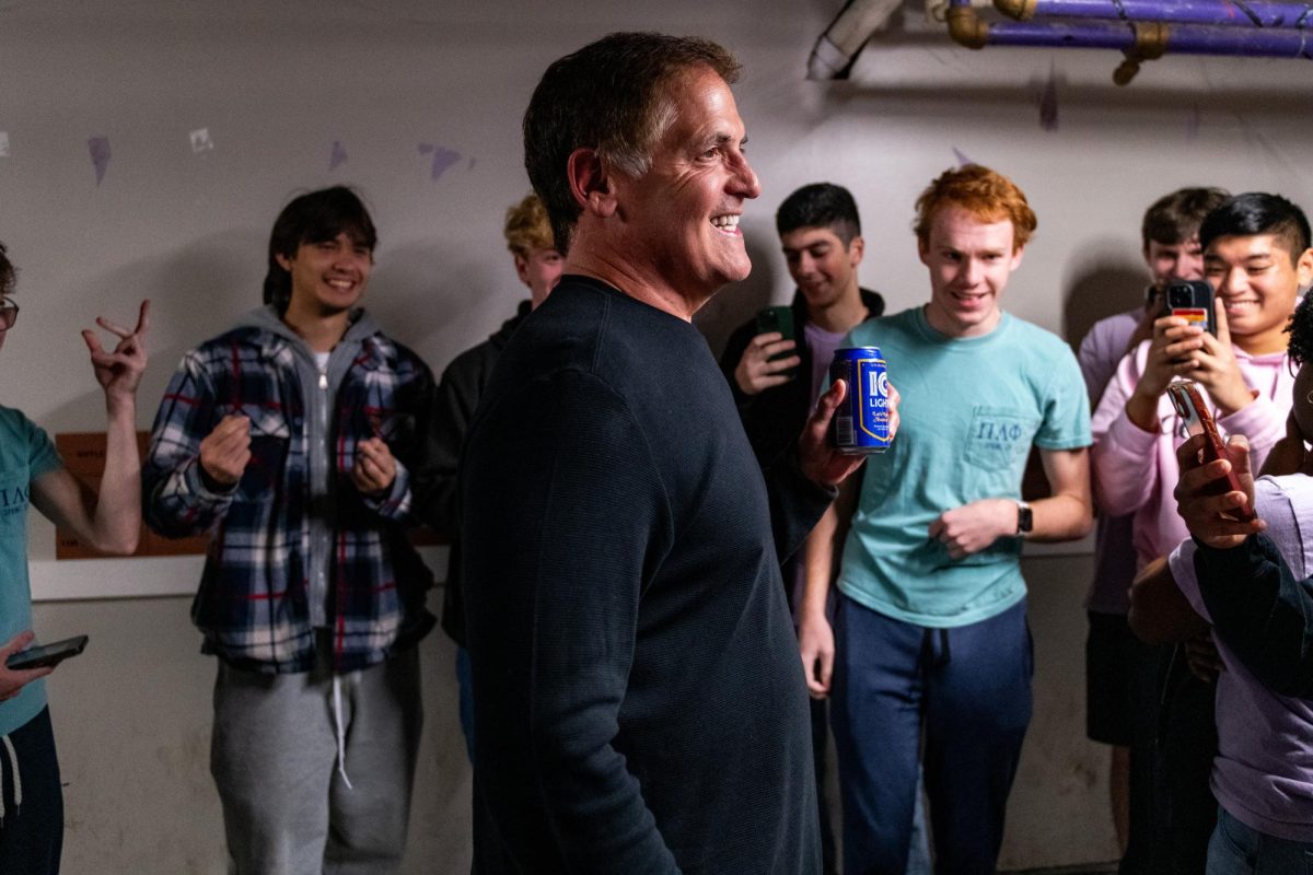 Mark Cuban smiles while holding an IC Light beer in the basement of the Pi Lambda Phi fraternity house on Oct. 26, 2024.