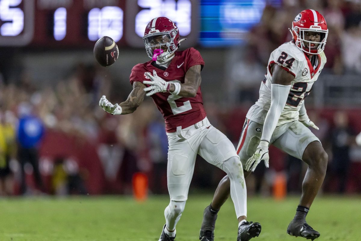 Alabama wide receiver Ryan Williams (2) makes a difficult bobbled catch with Georgia defensive back Malaki Starks (24) defending during the second half of an NCAA college football game, Saturday, Sept. 28, 2024, in Tuscaloosa, Ala.