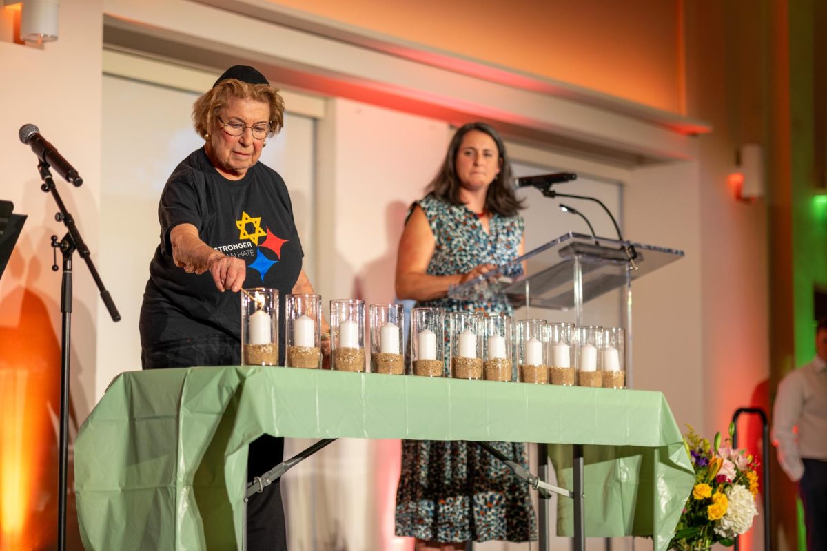 An attendee lights candles at the Tree of Life memorial service at the Jewish Community Center on Sunday, Oct. 27th.
