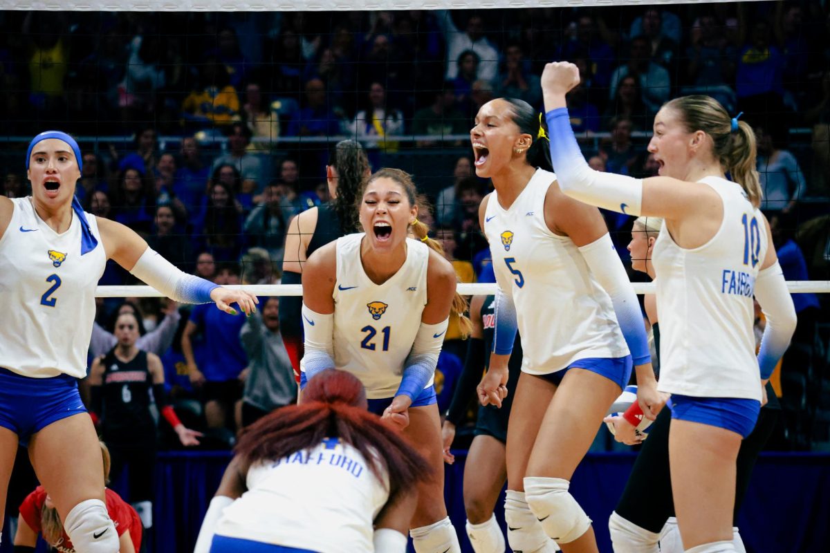 Pitt volleyball celebrates scoring a point against Louisville on Friday Oct. 25