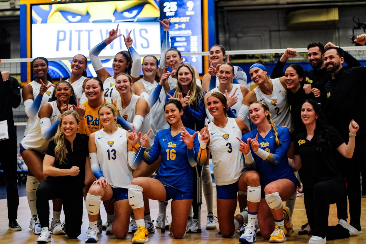 Pitt volleyball poses for a picture in celebration of its win against SMU in the Fitzgerald Field House on Wednesday.
