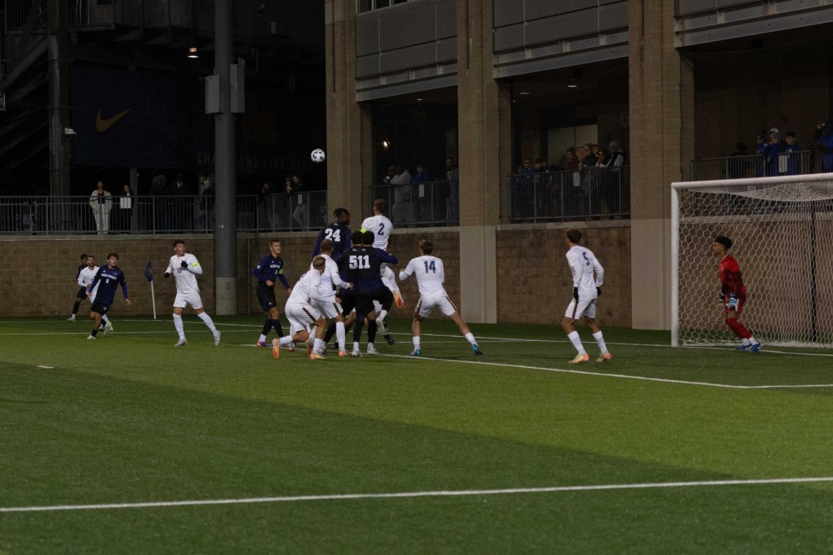 Pitt men’s soccer prepares to defend a cover kick on Monday at Ambrose Urbanic Field.