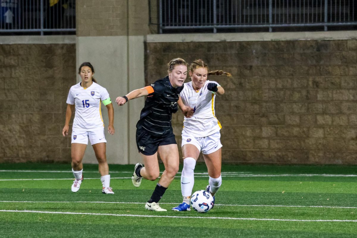 Senior midfielder Ellie Coffield (4) fights for the ball at the soccer game against Wake Forest at Ambrose Urbanic Field on Thursday, Oct. 24.