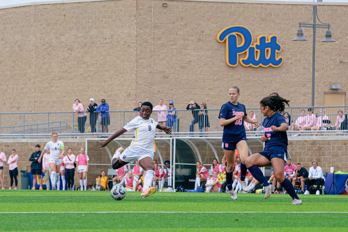 Sophomore midfielder Deborah Abiodun (8) prepares to kick the ball down the field at the soccer game against Syracuse at Ambrose Urbanic Field on Sunday.