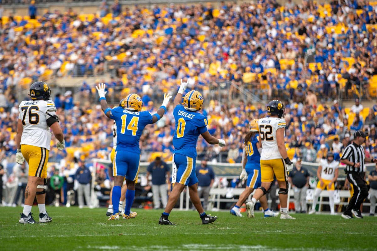 Sophomore linebacker Braylan Lovelace (0) signals to the crowd after a play at the Pitt football game against Cal at Acrisure Stadium on Saturday, Oct. 12.