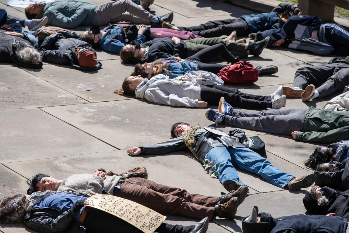 Protesters participate in a die-in in front of the Cathedral of Learning at an event hosted by Pittsburgh Palestine Coalition.