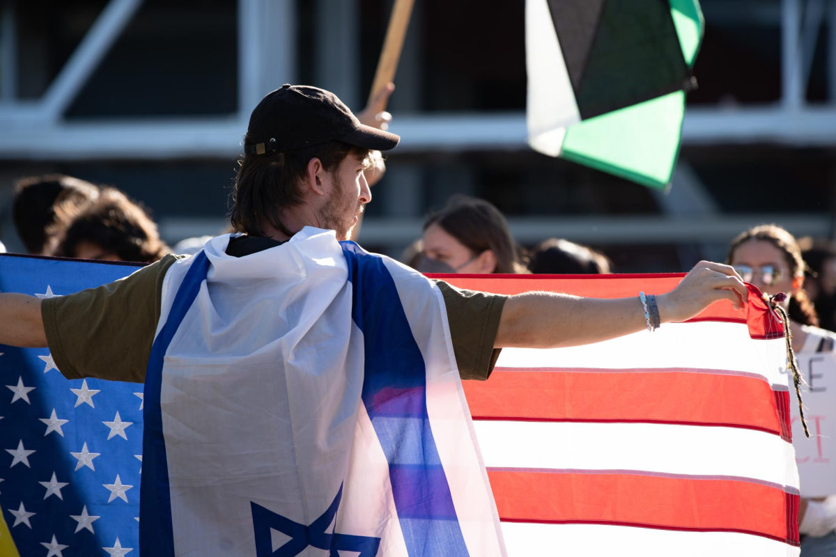 A pro-Israel protester holds an American flag during the event at Schenley Plaza on Tuesday, Sept. 3.
