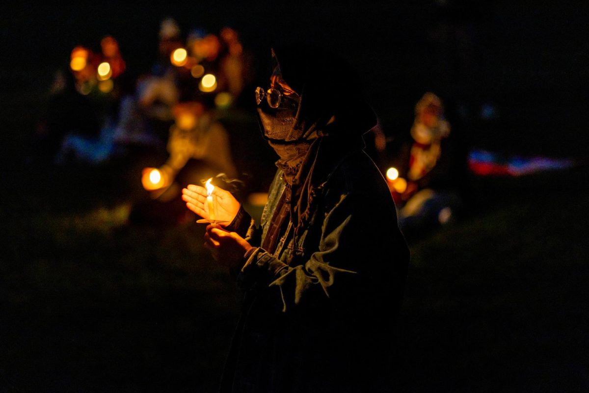 An attendee holds a candle during the Community Vigil for Gaza on Monday.