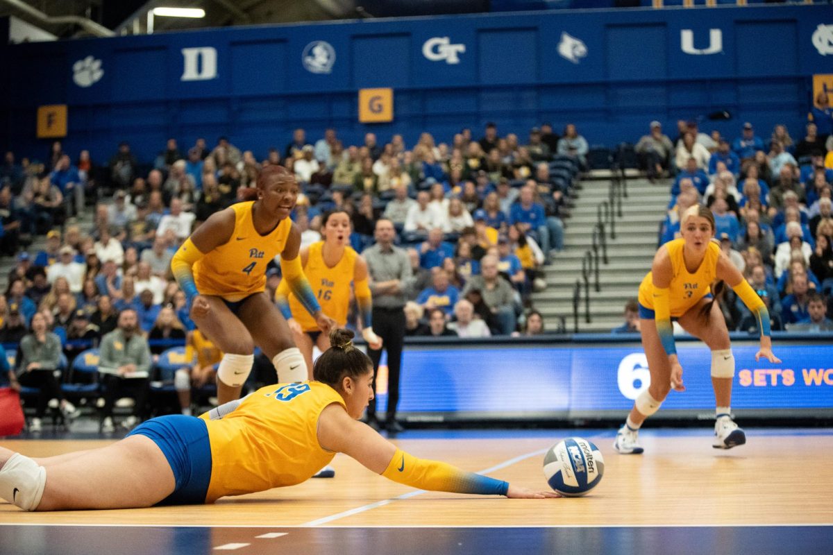 Pitt senior setter Nisa Buzlutepe (19) lunges for the ball at the volleyball game against Notre Dame in the Fitzgerald Field House on Sunday, Oct. 27.