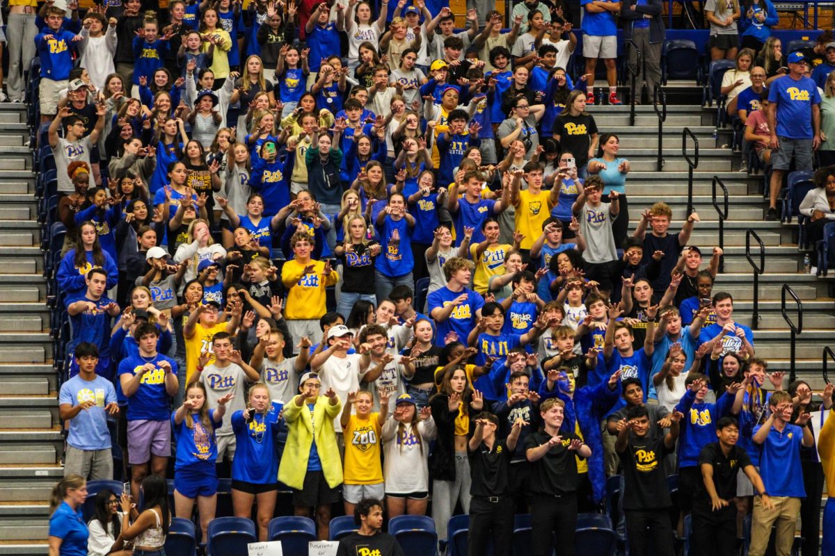 Members of the student section extend their arms during Pitt volleyball’s game against Buffalo on Tuesday, Sept. 3 at Fitzgerald Field House.