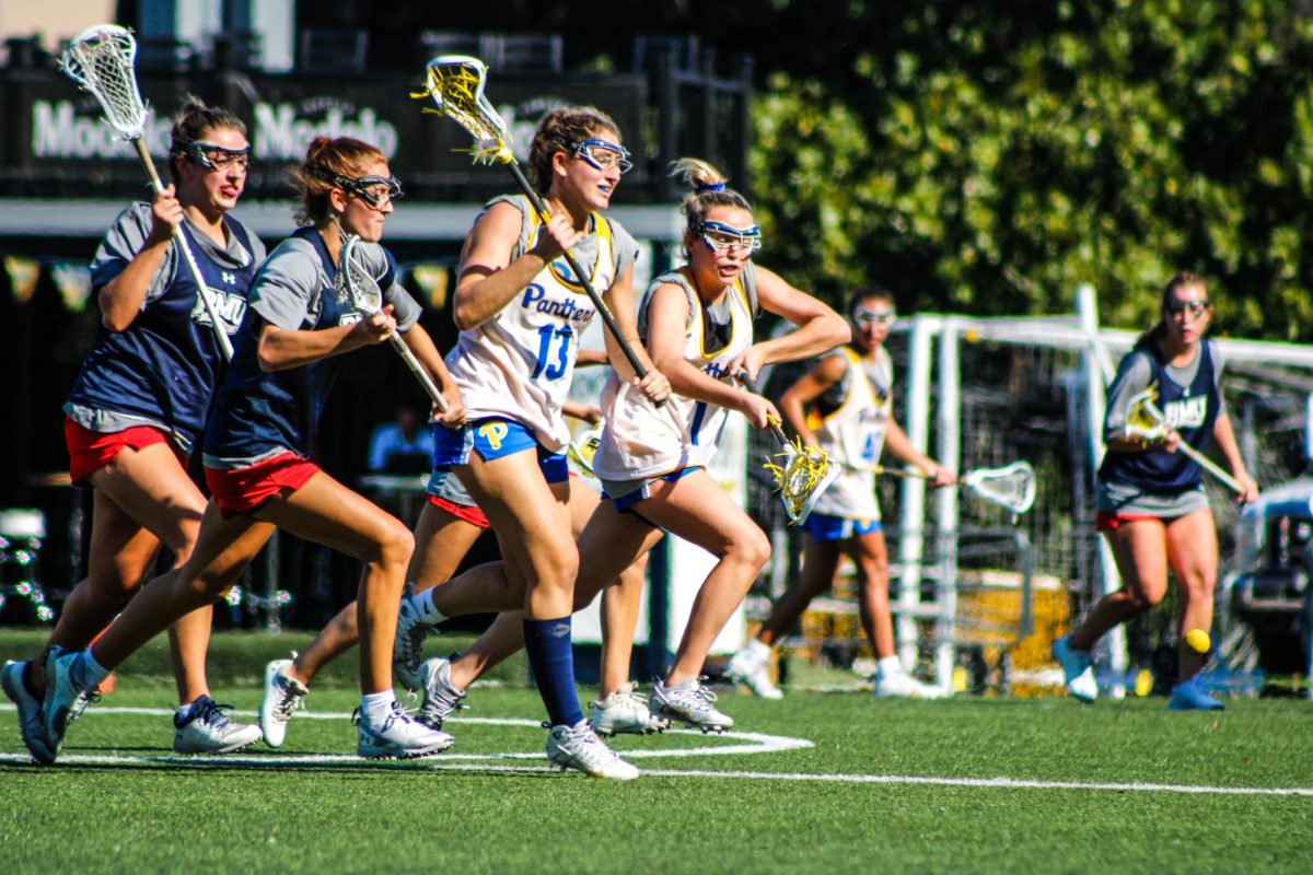 Redshirt junior midfielder Maria Donahue (13) and sophomore midfielder Kaitlyn Giandonato (1) charge for the ball at Pitt Play Day.
