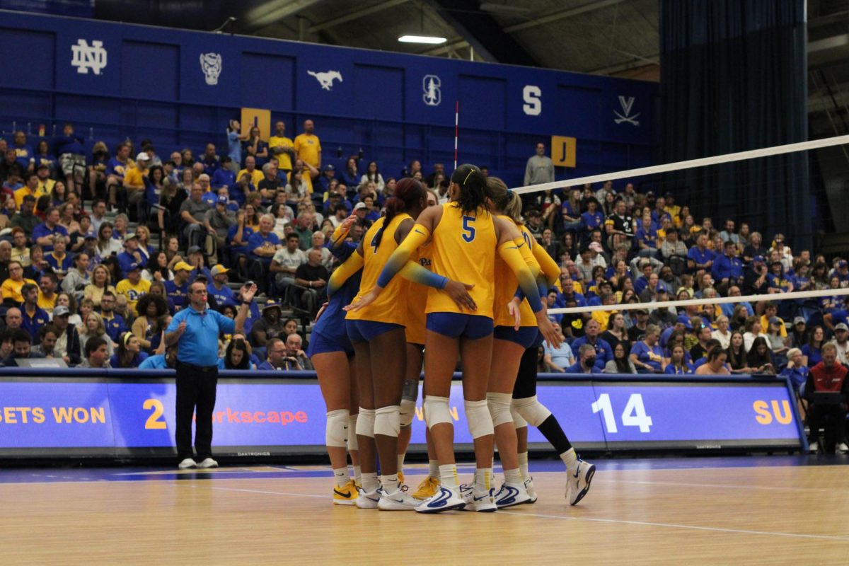 Pitt volleyball huddles at the volleyball game against Stanford in the Fitzgerald Field House on Sunday.