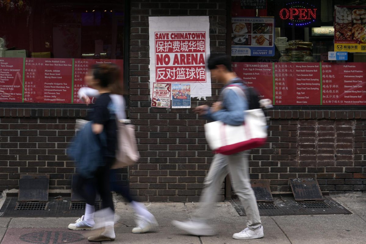 People walk through the Chinatown neighborhood of Philadelphia, Wednesday, Sept. 18, 2024.