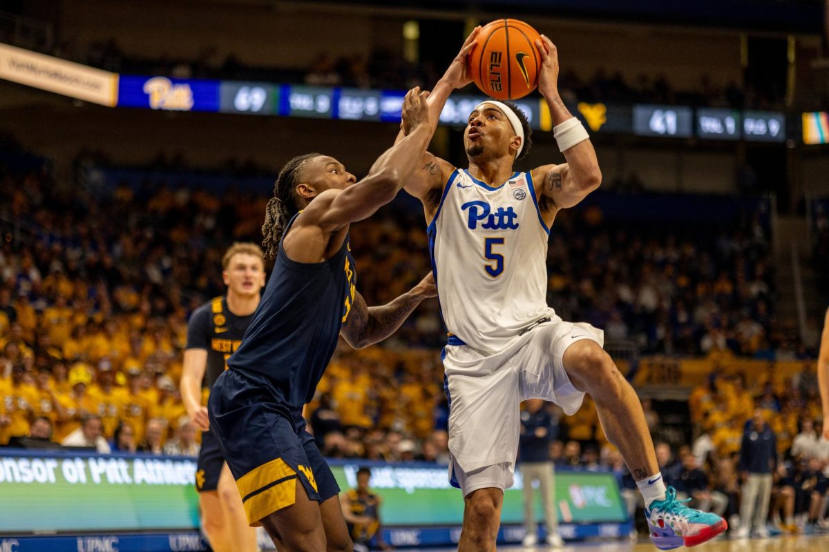 Senior guard Ishmael Leggett (5) prepares to shoot the ball during the Pitt men's basketball game against West Virginia in the Petersen Events Center on Friday, Nov. 15.
