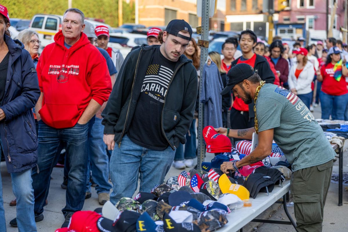 A Trump supporter looks at hats for sale prior to former President Trump’s rally at PPG Arena on Nov. 4, 2024.