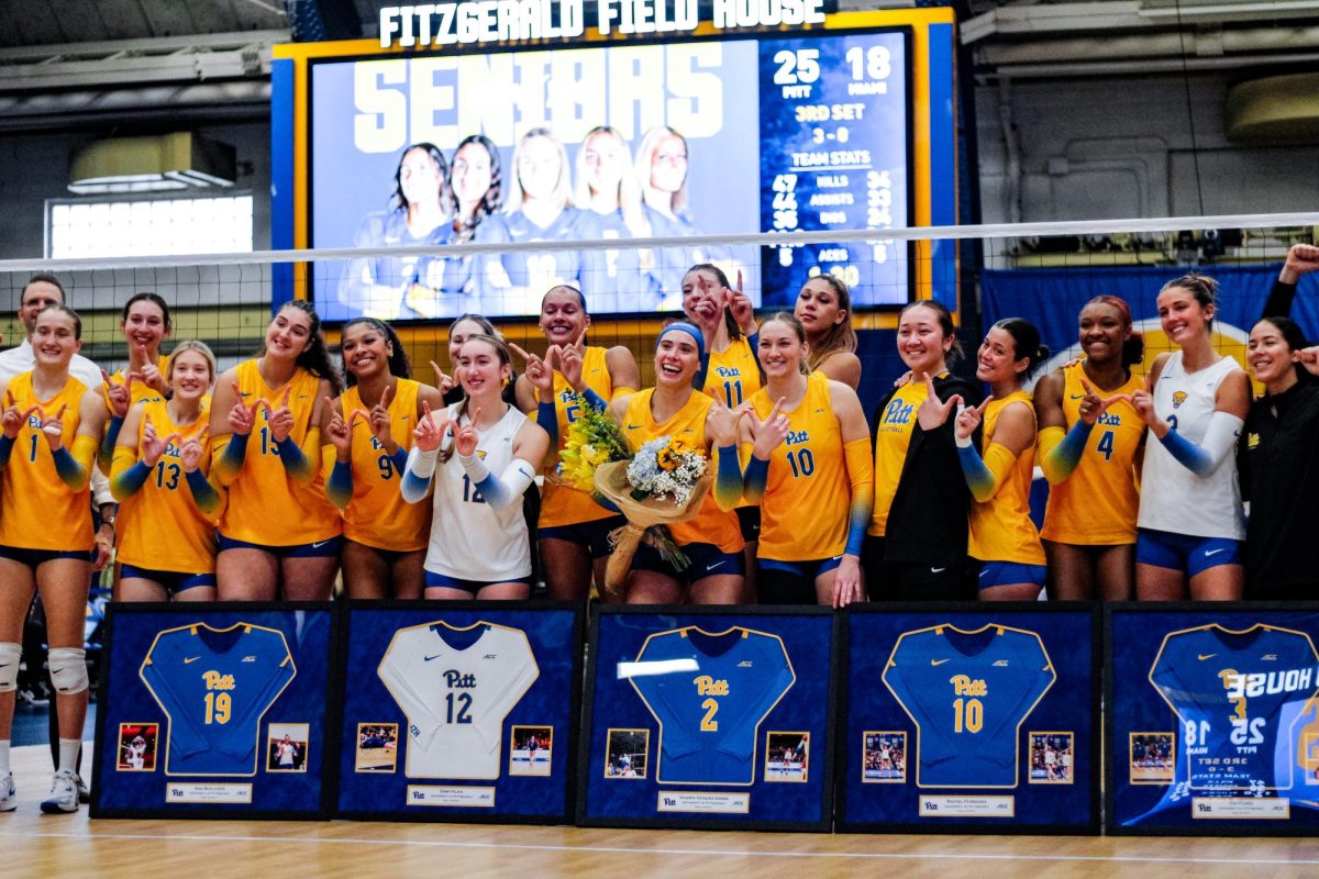 The Pitt Volleyball team poses for a team photo following their victory over Miami at Fitzgerald Field House on Sunday, Nov. 17.