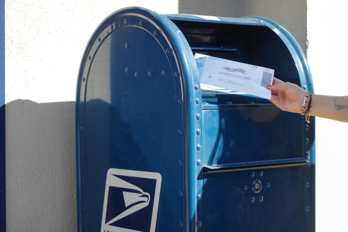 A ballot gets placed in a mailbox.