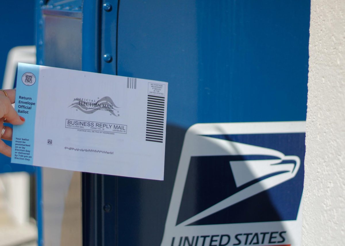 A ballot gets placed in a mailbox.