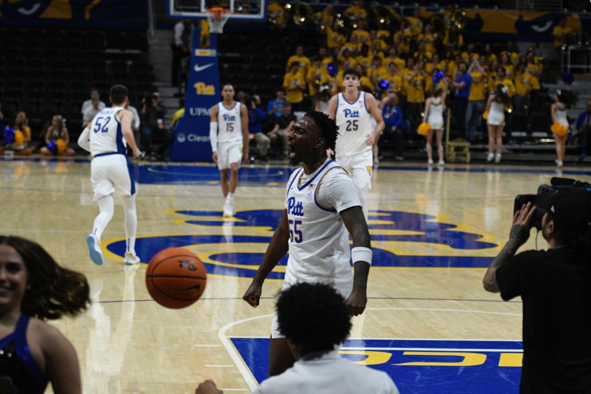 Redshirt senior forward Zack Austin (55) celebrates after dunking the ball during Pitt men’s basketball’s game against Gardner-Webb.