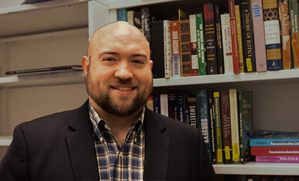 Teaching assistant professor of political science Jacob Schiller poses for a portrait.