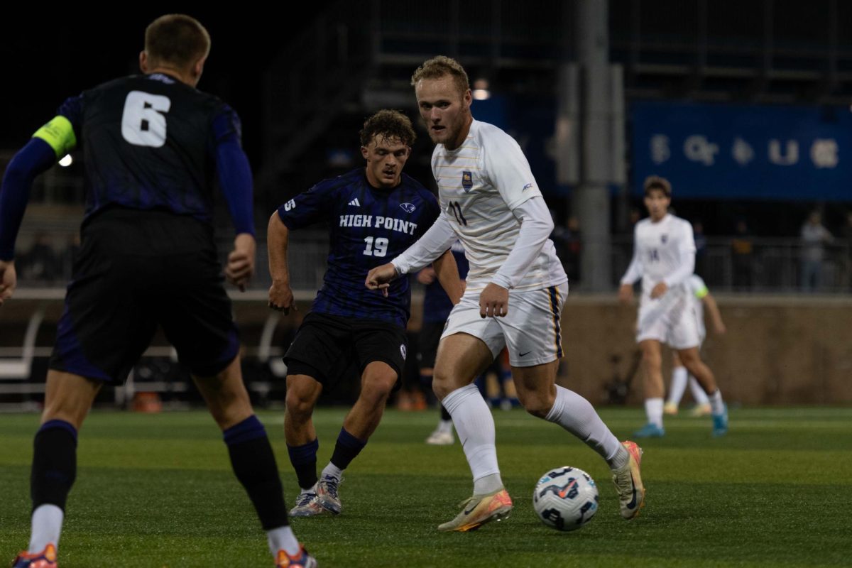 Senior midfielder Casper Grening (11) looks to pass on Monday at Ambrose Urbanic Field.