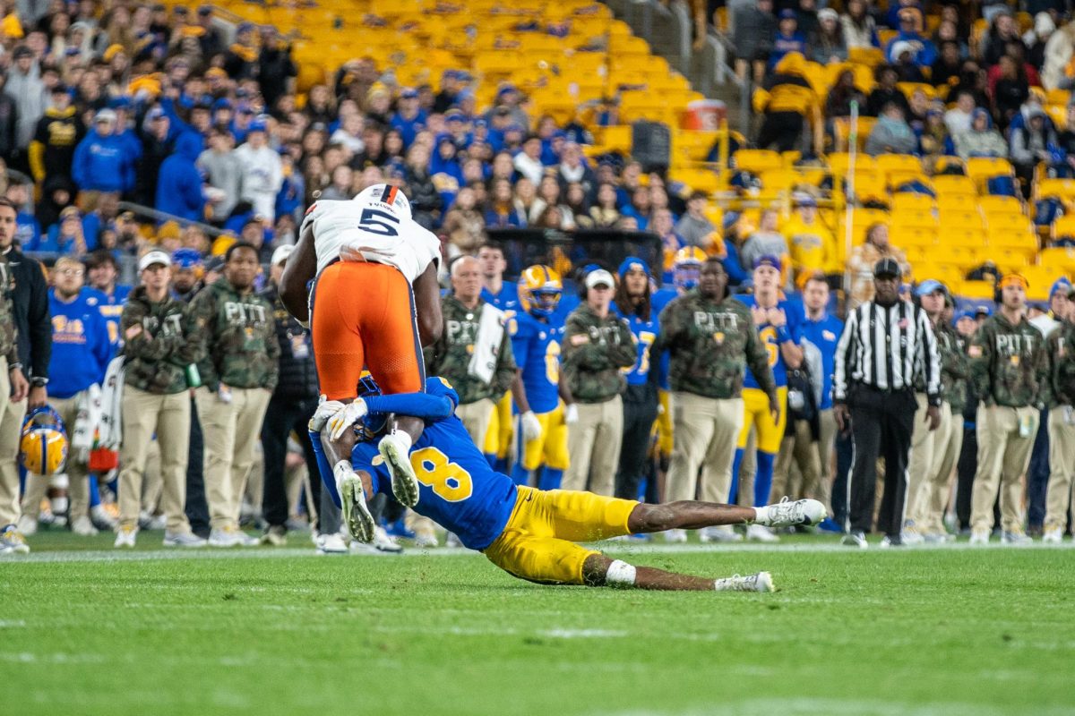 Redshirt senior defensive back Tamon Lynum (8) tackles a Virginia player at the Pitt football game in Acrisure Stadium on Saturday, Nov. 9.