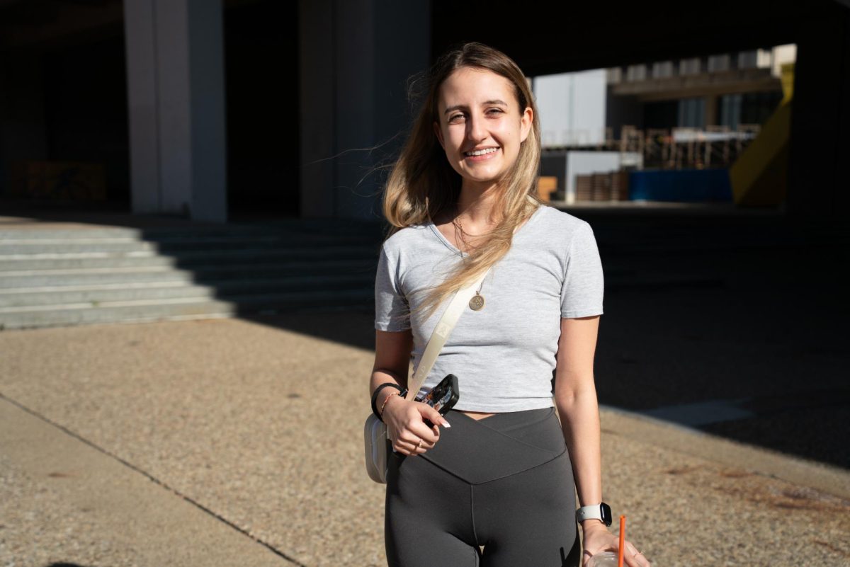 Sara Thomas, a recent graduate, poses for a picture outside Posvar Hall after voting on Tuesday, Nov. 5.
