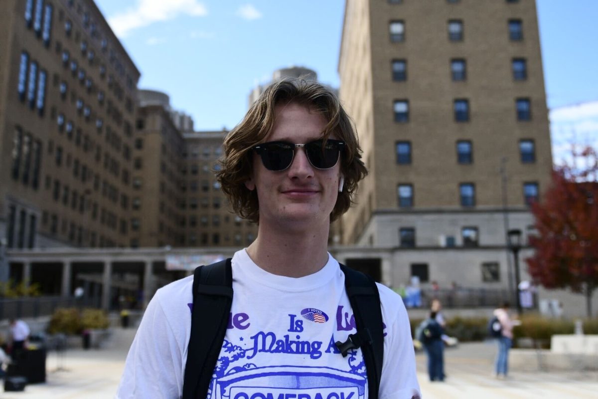 Andrew Lindros, a law and criminal justice systems student, smiles for a photo outside the William Pitt Union after voting on Tuesday, Nov. 5.