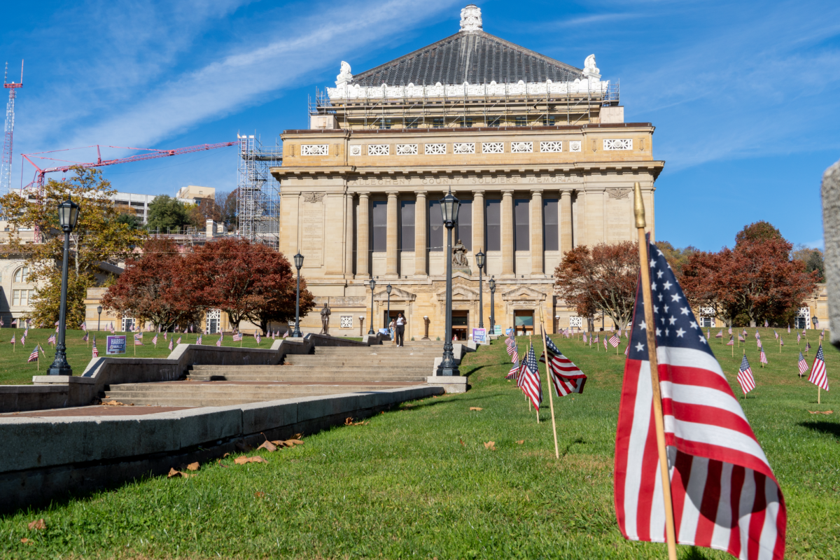 American flags decorate the lawn of Soldiers and Sailors Memorial Hall & Museum. 
