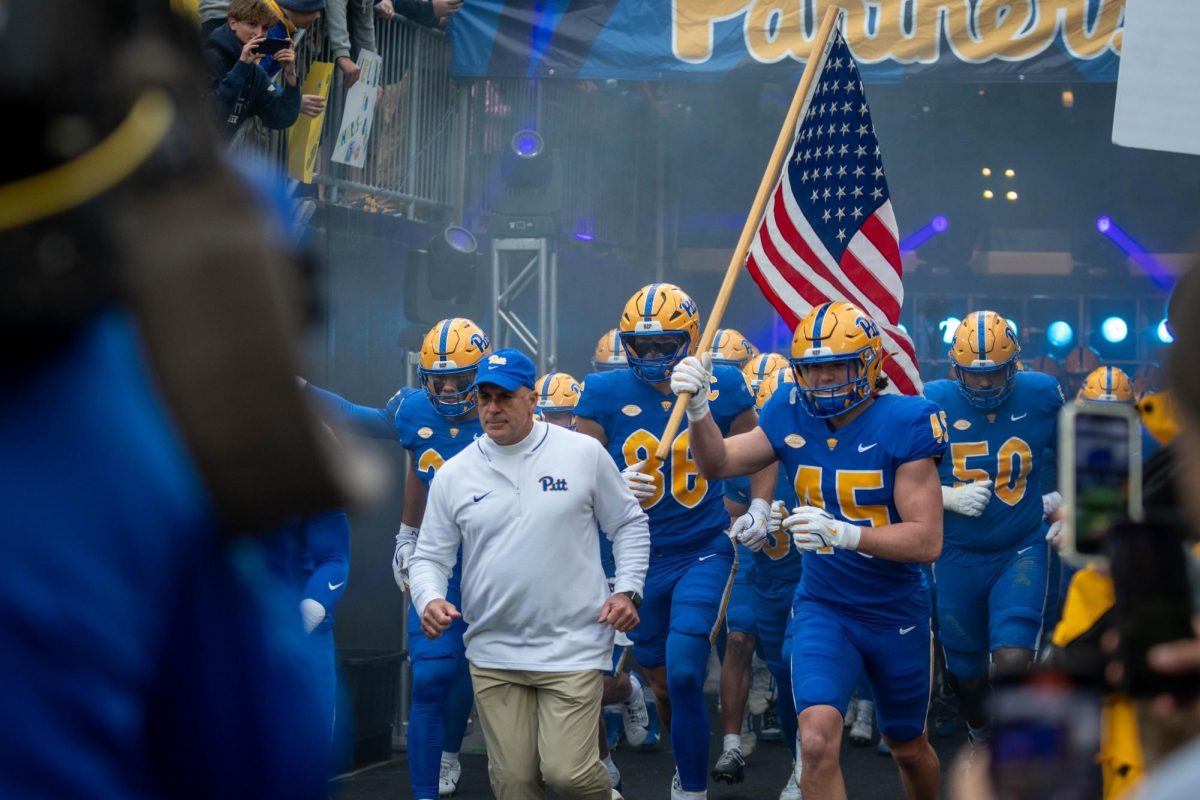 Pitt football runs onto the field with head coach Pat Narduzzi during the game against Clemson in Acrisure Stadium on Saturday, Nov. 16.
