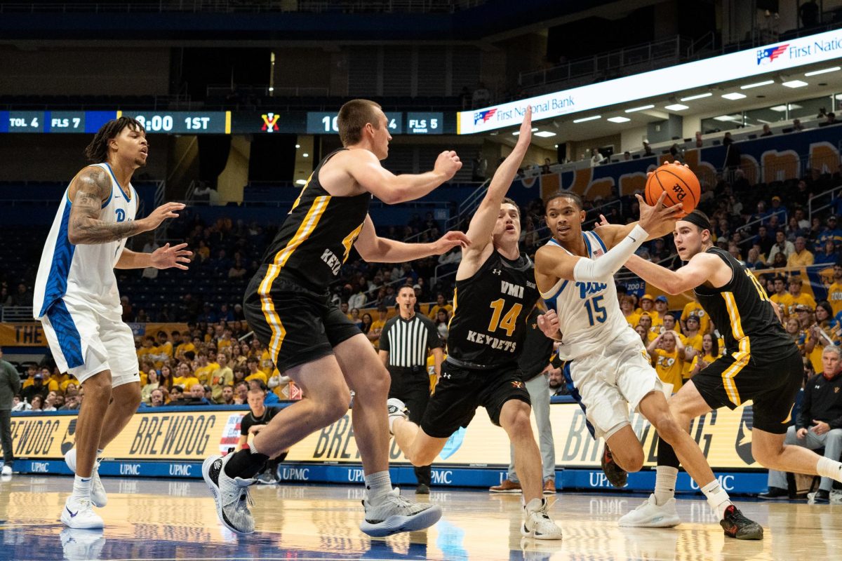 Sophomore Guard Jaland Lowe (15) drives the ball during Pitt men’s basketball’s game against VMI at the Petersen Events Center on Monday, Nov. 18.